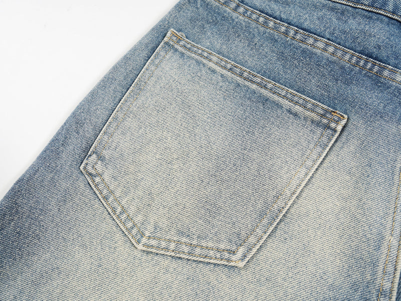 Close-up of back patch pocket on light faded denim shorts