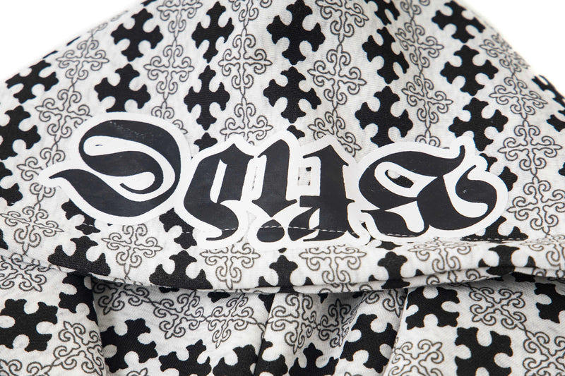 Close-up of hood with black gothic lettering and cross pattern