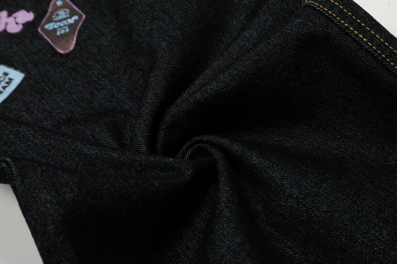 Close-up of black denim fabric texture and seam stitching