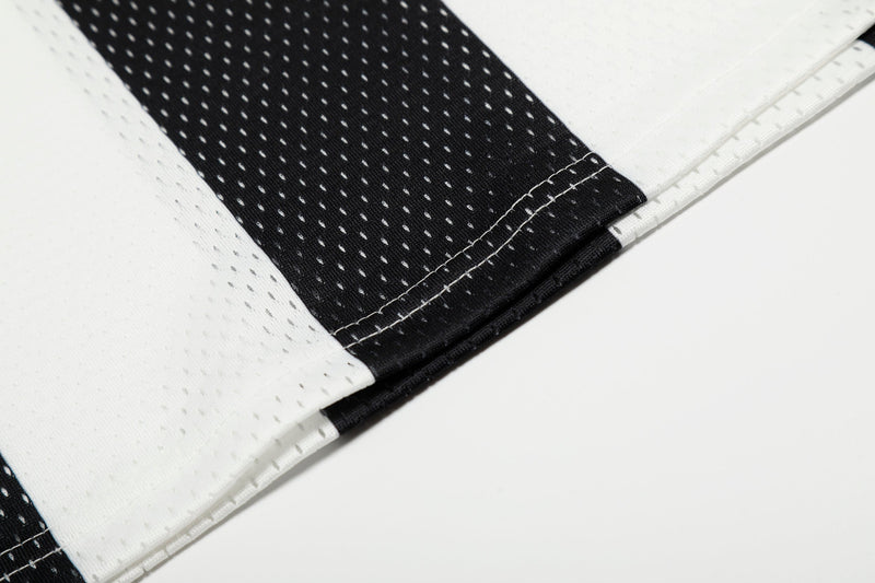 Close-up of black cuff and stitched sleeve seam on striped jersey