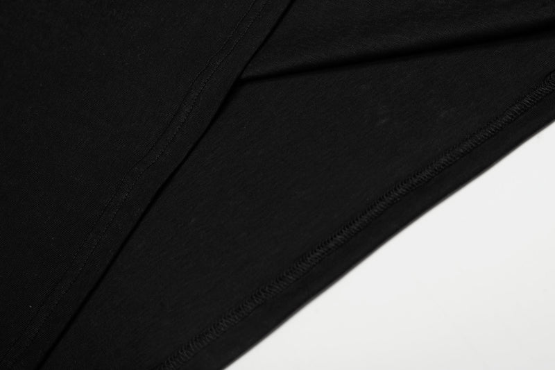 Close-up of black shirt fabric and side seam stitching