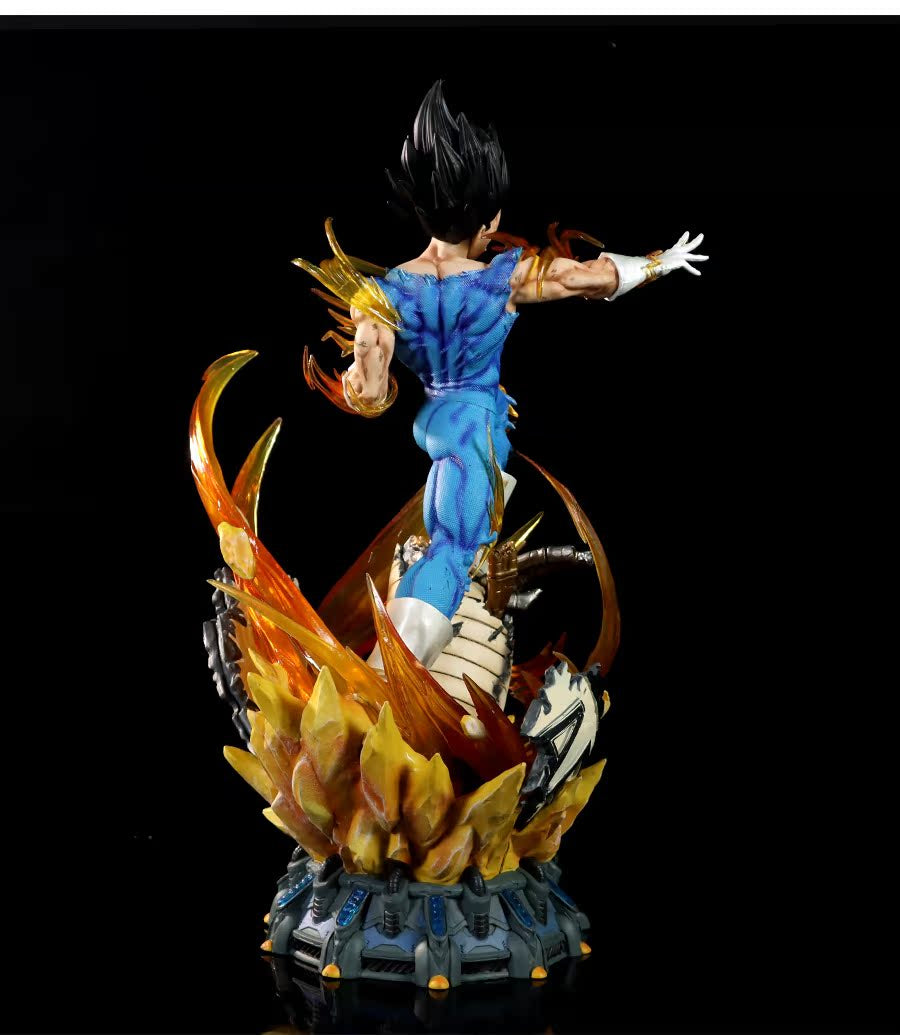 The Seakoff Vegeta Super Saiyan Collectible Figure captures a muscular character with spiky black hair in a dynamic pose. Featuring interchangeable heads and glowing effects, the 45cm figure dons a blue suit, white boots, and stands on an intricately detailed base surrounded by flames and energy.