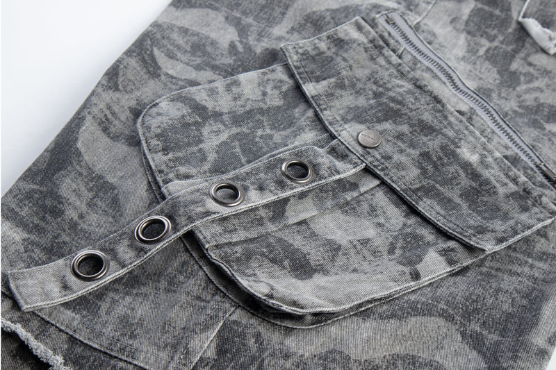 Close-up of gray camo cargo pocket with flap and grommet trim