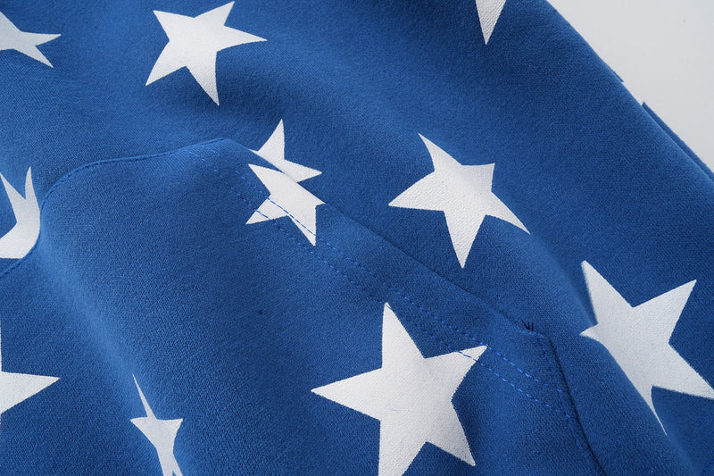 Close-up of blue hoodie kangaroo pocket and star print stitching detail