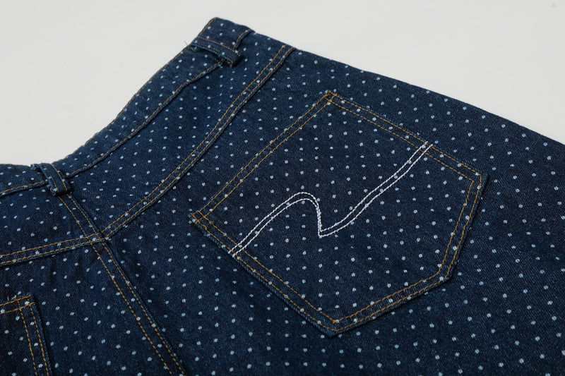 Back pocket close-up on navy polka dot denim cargo shorts with contrast stitching