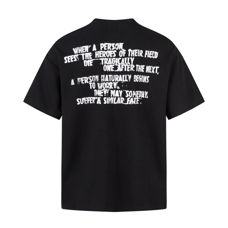 Black half-zip neck streetwear T-shirt with oversized white graphic text printed across the back