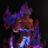 The Seakoff Goku Ultra Instinct Collectible Figure – Dragon Ball is a 35cm glowing statue featuring a spiky-haired anime character standing amid colorful translucent flames, illuminated in purple and red. This shirtless, muscular figure resembles Goku wearing loose pants.