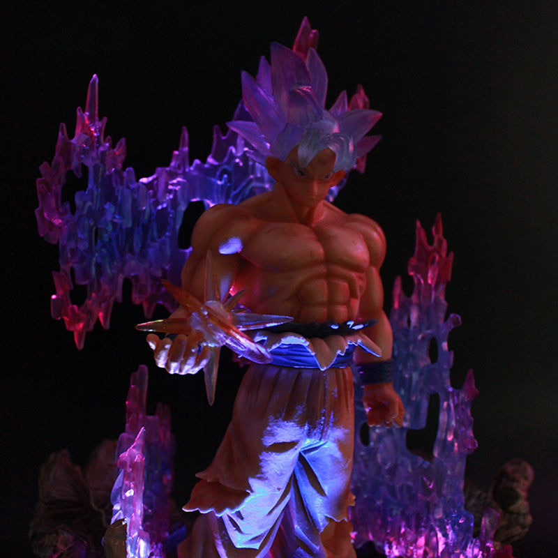 The Seakoff Goku Ultra Instinct Collectible Figure – Dragon Ball is a 35cm glowing statue featuring a spiky-haired anime character standing amid colorful translucent flames, illuminated in purple and red. This shirtless, muscular figure resembles Goku wearing loose pants.