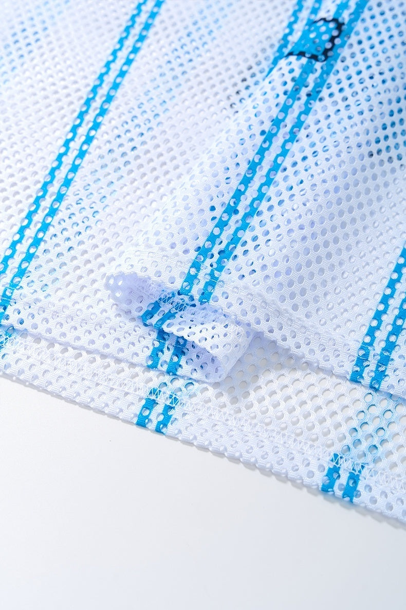 Close-up of white mesh jersey fabric with blue vertical stripes and stitched hem detail