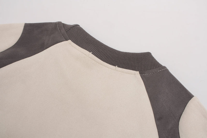 Close-up of a beige and charcoal panel suede tee with ribbed crew neckline and stitched shoulder detailing