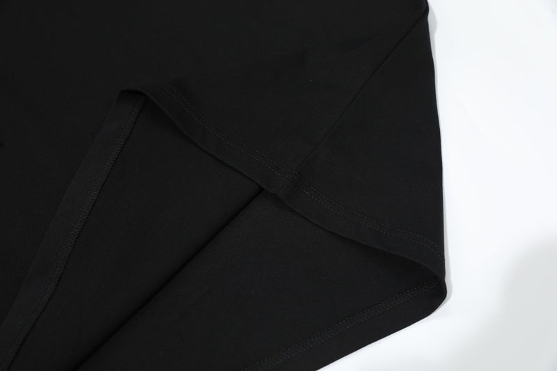 Black oversized T-shirt with visible hem stitching and soft drape on a clean white background