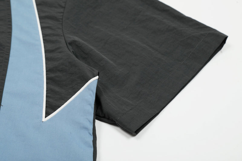 Black and light blue nylon hooded half-zip jersey sleeve with varsity-style contrast panel and trim