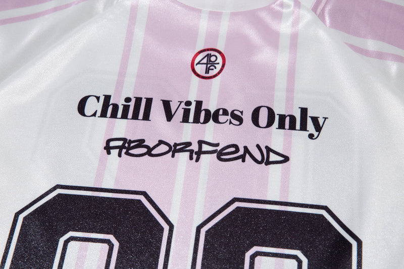 Close-up of white jersey front showing Chill Vibes Only text and chest logo