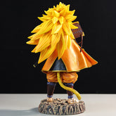 The Goku Samurai Collectible Figure by Seakoff, inspired by Dragon Ball Z, features Goku with spiky yellow hair, an orange-yellow cloak, blue pants, and brown boots. It stands on a round base with a sword slung over his back against a dark backdrop highlighting its samurai-inspired design.