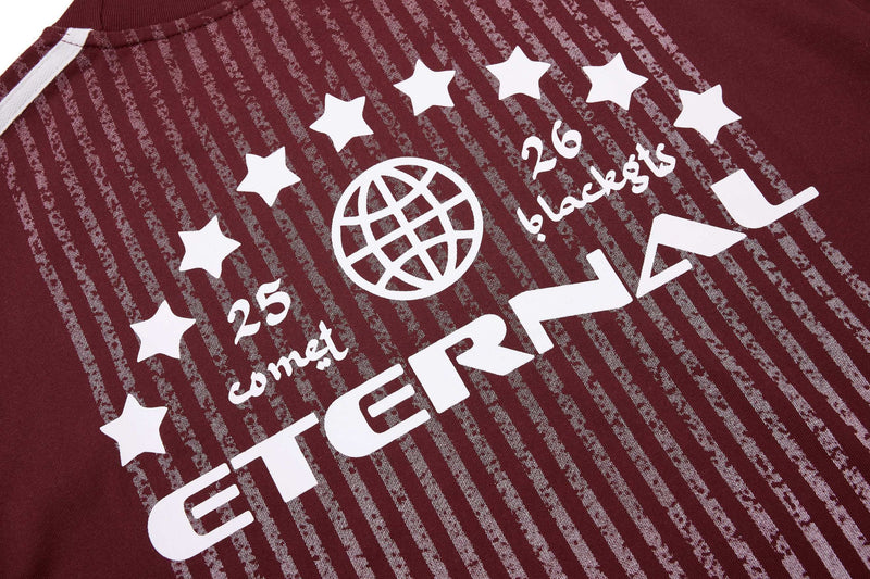 Maroon sport tee with white stripe graphics, stars, and bold graphic text across the chest.