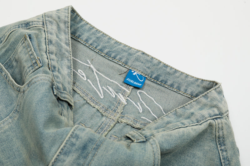 Interior waistband of light wash jeans with blue brand label