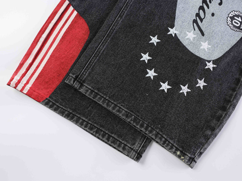 Close-up of black denim hem with red panel, white stripes, and star print