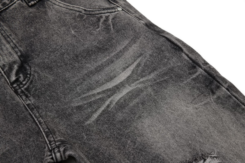 Close-up of faded denim thigh with subtle whiskering and side seam