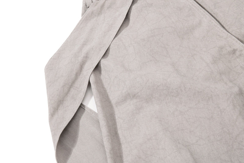 Light beige denim side panel close-up showing wide-leg drape and side slit seam