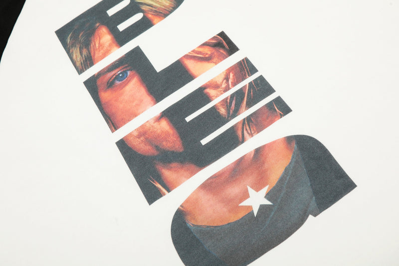 Close-up of vertical front graphic with facial features and star detail on white fabric
