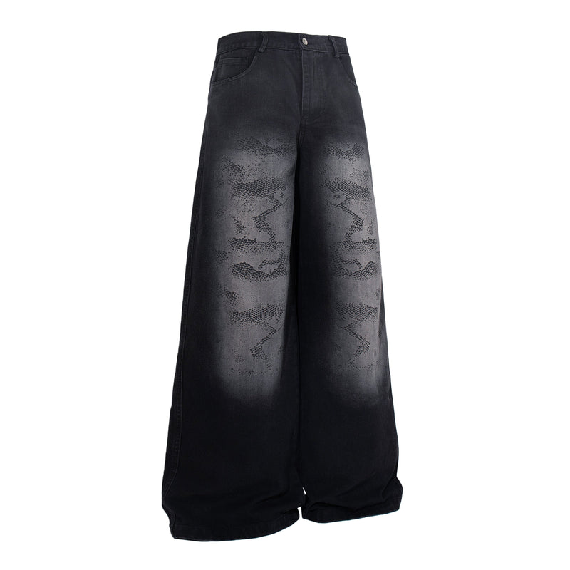 Angled front view of dark wide-leg jeans with faded camo pattern