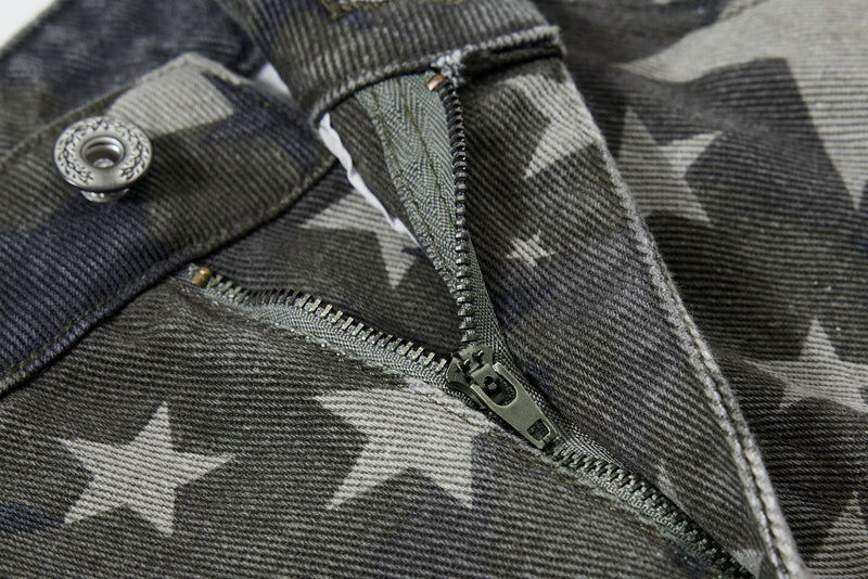 Close-up of zipper fly and button on star print jeans