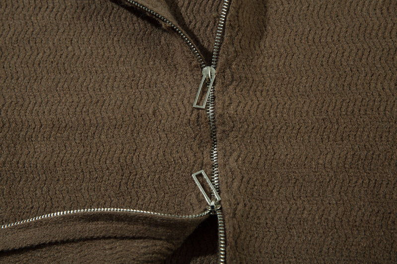 Close-up of the brown zip-up hoodie front with silver zipper pull and knit texture