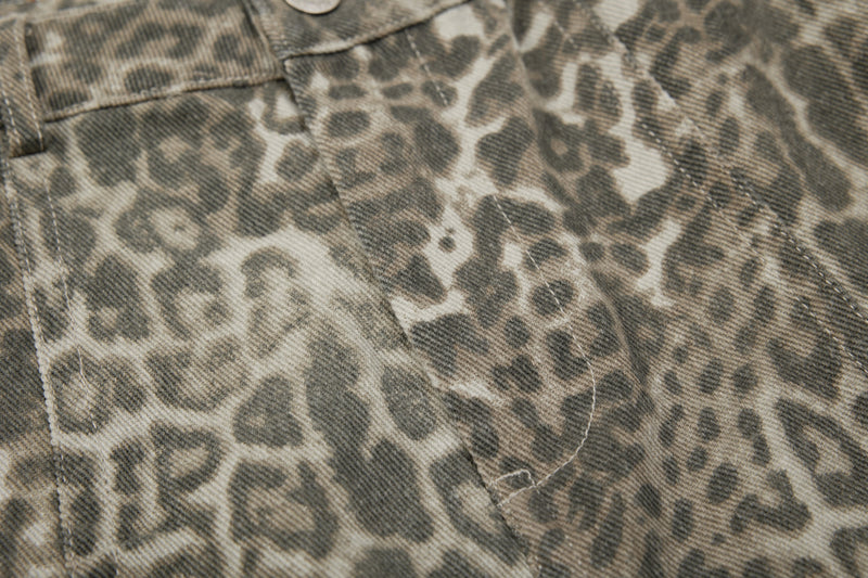 Close-up of leopard print fabric with curved seam detail on the pants