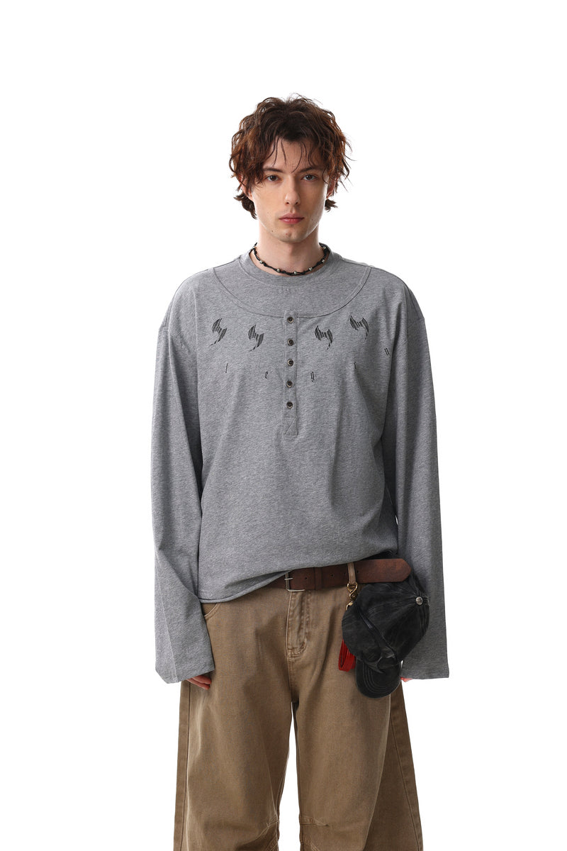 Gray henley tee worn by model, front view with graphic print