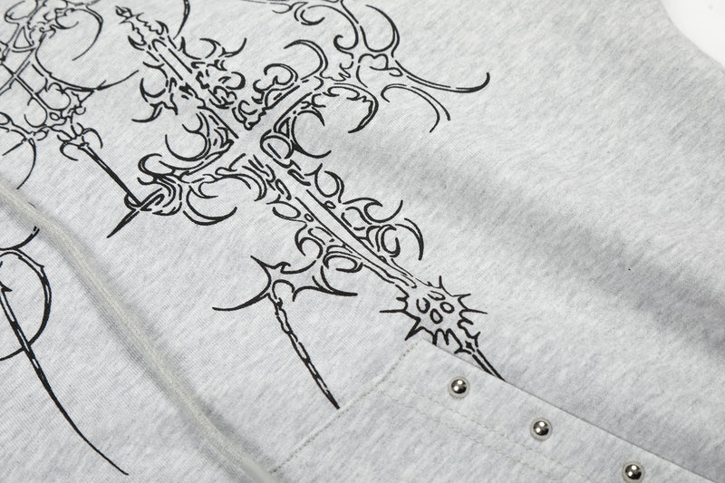 Close-up of light gray hoodie front pocket with metal rivet detail and cross print