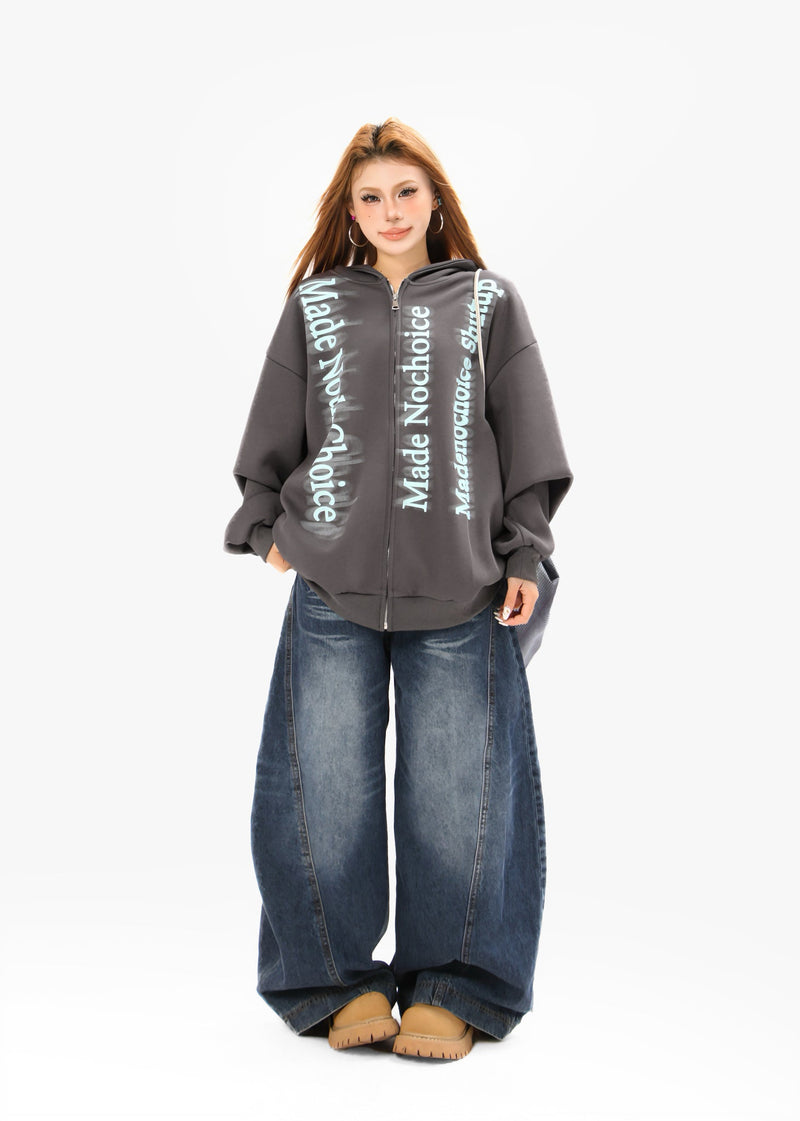 Charcoal zip hoodie full-body model view with blue gradient lettering and wide jeans