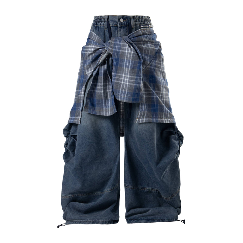 Blue layered plaid baggy jeans shown front view with oversized plaid panels tied at the waist