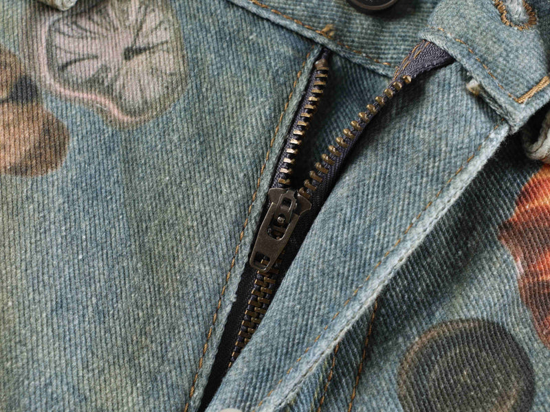 Close-up of the front zipper opening on printed denim jeans