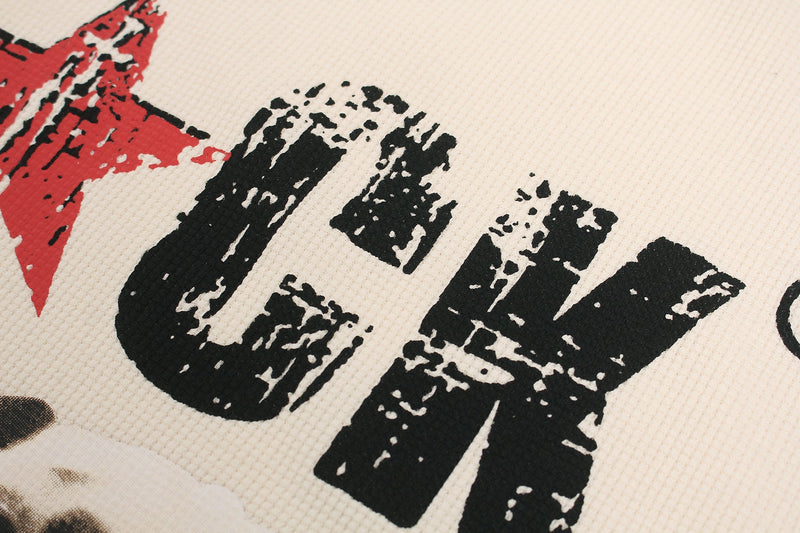 Close-up of distressed black and red graphic print on cream waffle-knit streetwear T-shirt fabric