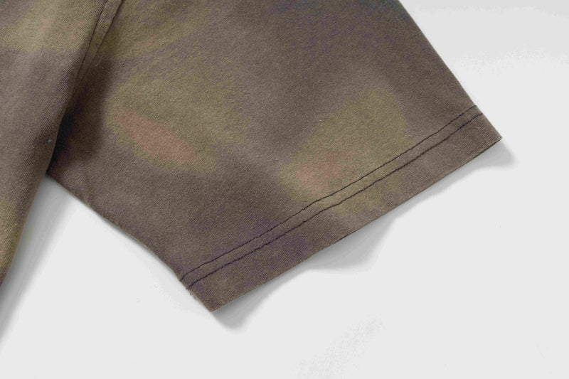 Washed brown vintage streetwear tee sleeve with abstract sketch print and visible hem stitching