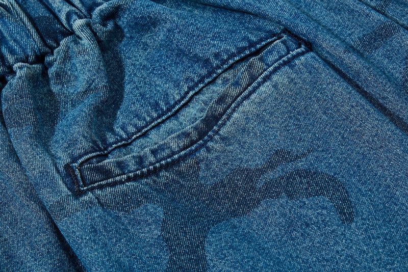 Close-up of back patch pocket on washed blue camo denim