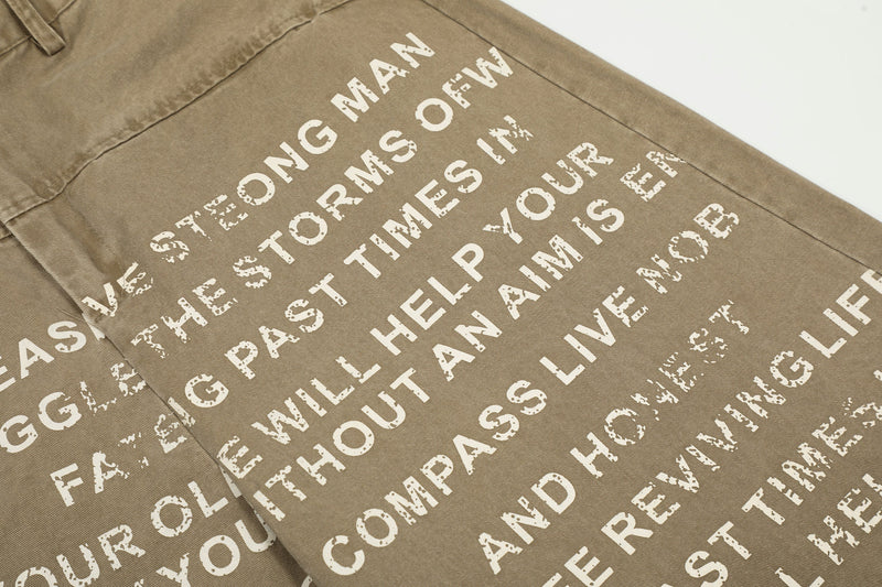 Close-up of printed text across the leg on khaki wide-leg pants