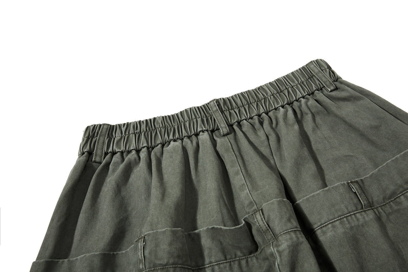 Close-up of olive green elastic waistband with gathered back panel