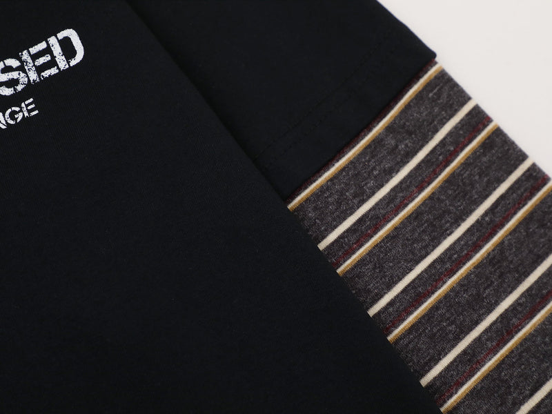 Close-up of black sleeve and ribbed striped cuff with gray heathered texture