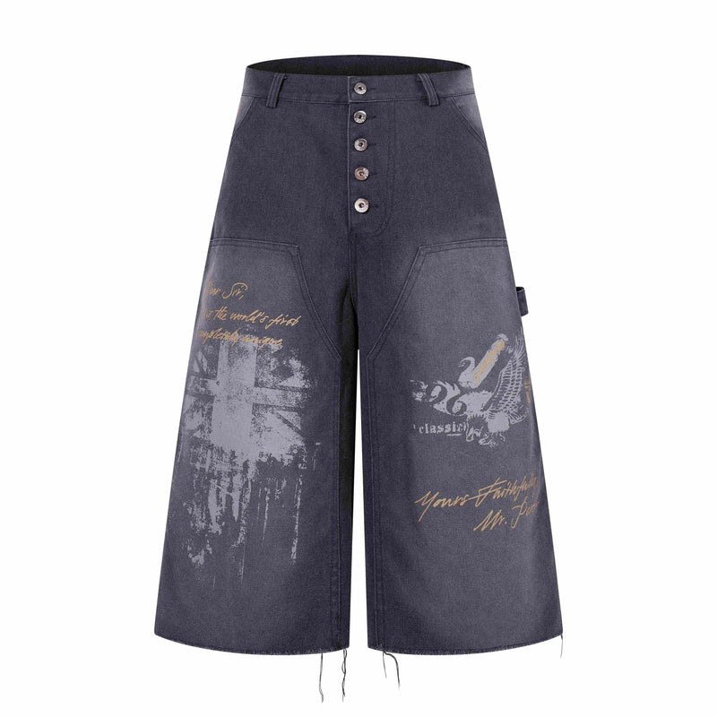 Front view of dark denim wide-leg shorts with button fly and vintage graphic print