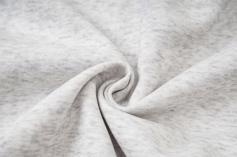 Close-up of light gray heathered hoodie fabric with soft folds