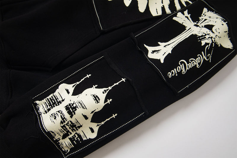Black hoodie sleeve with white graphic print and gothic script