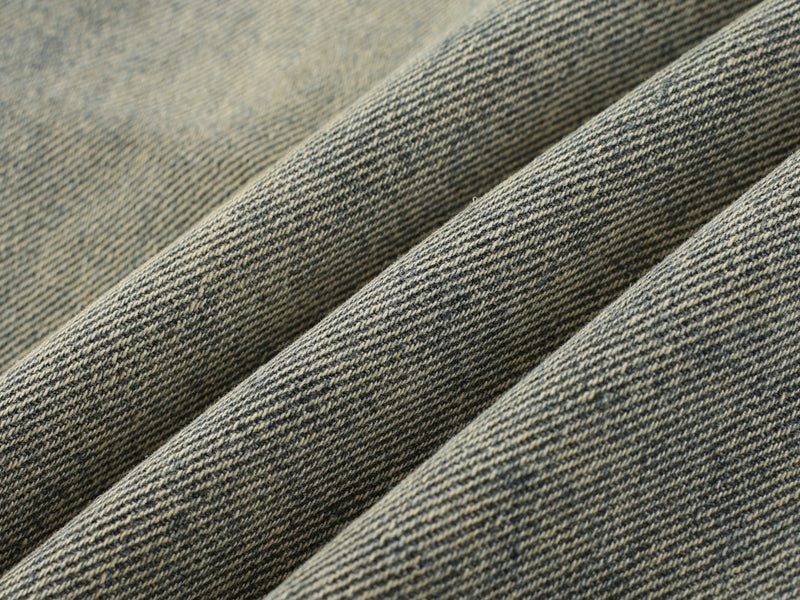 Close-up of textured vintage wash denim fabric folds