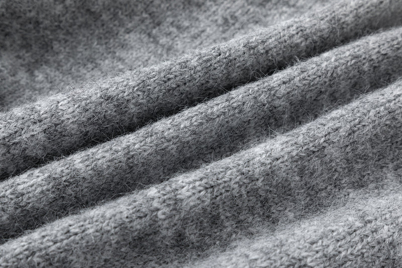 Close-up of gray wool blend knit fabric with fuzzy ribbed texture