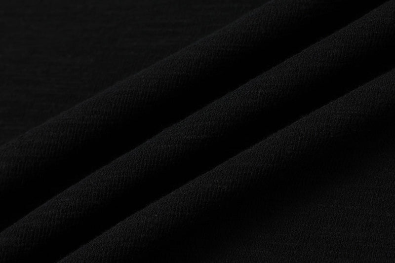 Black textured polo fabric with subtle diagonal stripe details, showing a close-up of the Seakoff streetwear tee material