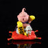 The Seakoff Majin Buu Collectible Figure - Dragon Ball Z Statue, 8.5cm tall, Lucky New Year Edition, features the pink character with boxing gloves on a red cushion beside a white puppy figure holding a Japanese-inscribed rectangular object against a black backdrop.