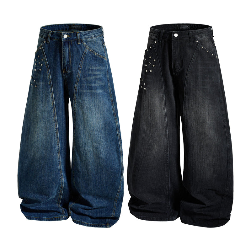 Blue and black wide-leg denim jeans with studded panel details, front view