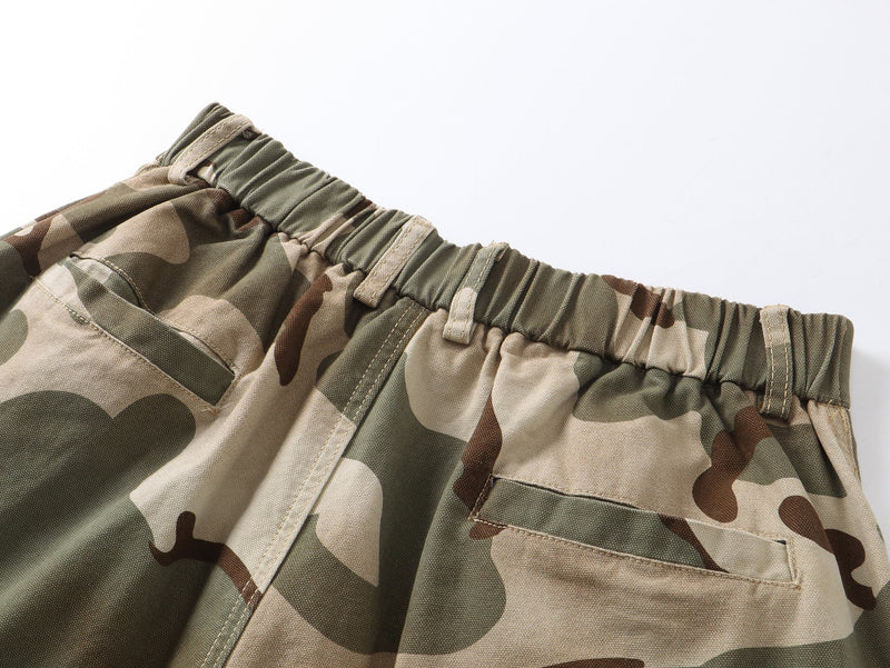 Close-up of elastic waistband on camouflage pants with belt loops and gathered fabric