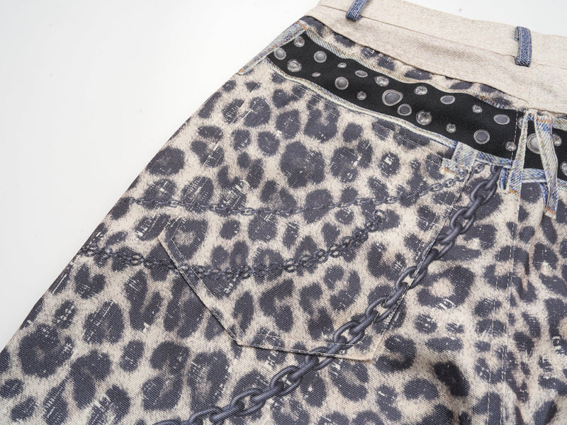 Close-up of leopard print back pocket, denim patch pocket, and black belt strip at the waist