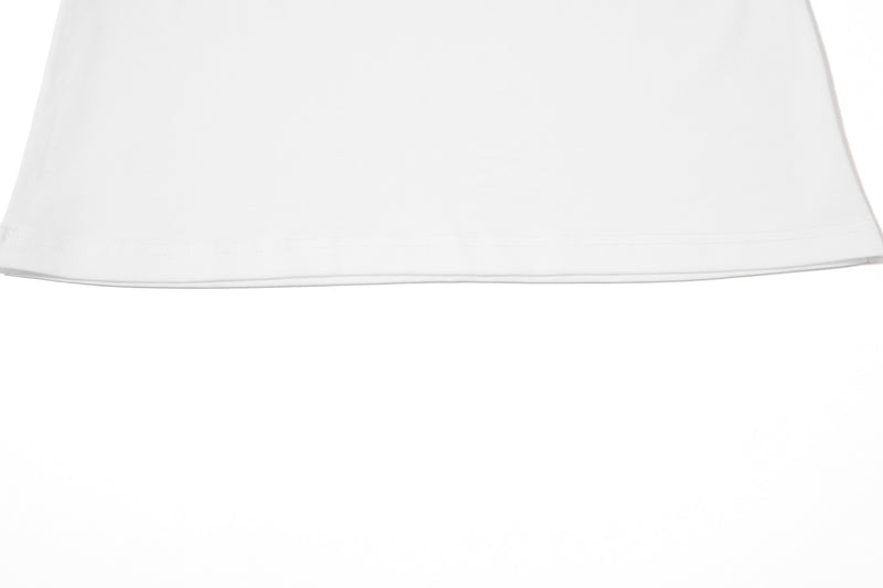 White distressed graphic polo shirt hem with subtle stitching and clean minimal streetwear style
